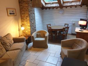 a living room with a couch and chairs and a table at Le basecamp des sommets in Stavelot