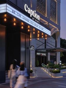 a building with people walking in front of it at Caption by Hyatt Zhongshan Park Shanghai in Shanghai
