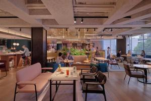 a rendering of a restaurant with tables and chairs at Caption by Hyatt Zhongshan Park Shanghai in Shanghai