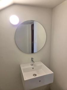 a bathroom with a white sink and a mirror at Aqua blue bay villa in Covelong +2 photos
