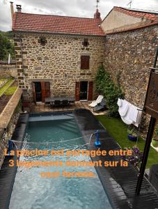 a swimming pool in front of a house at Cozy Home in Langeac