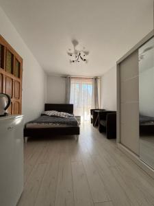 a bedroom with a bed and a living room at Marszałek Mielno in Mielno