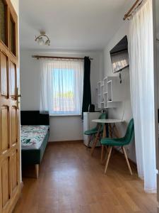 a small room with a bed and a table and chairs at Marszałek Mielno in Mielno