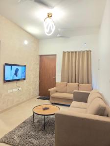 a living room with a couch and a table at Aqua blue bay villa in Covelong