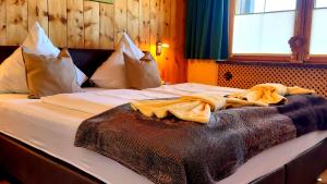 a bed with white sheets and pillows on it at Ferienwohnung Zirbenduft in Inzell