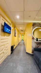 a hallway in a hospital with a tv on a wall at Haven Hub in Abu Dhabi