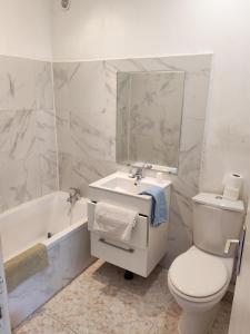 a bathroom with a toilet and a sink and a tub at Hotel Le Bois Des Espeisses in Nîmes +22 photos