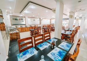 a dining room with a table and chairs at Hotel Sandra Palace in Thekkady