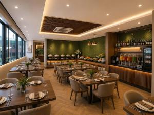 a restaurant with tables and chairs and a bar at Minerva Prestige Hotel in Hanoi