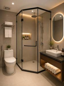 a bathroom with a shower and a toilet and a sink at Minerva Prestige Hotel in Hanoi +16 photos