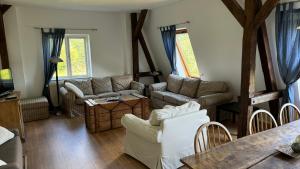 a living room with couches and a table at Landhaus Panker in Panker