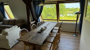 a living room with a wooden table and chairs at Landhaus Panker in Panker