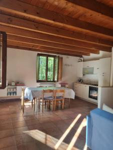 a kitchen with a table and chairs in a room at Agriturismo Case in Collina in Volta Mantovana