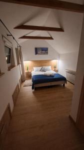 a bedroom with a bed with a blue comforter at Polana Jabłonka in Jabłonka