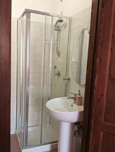 a bathroom with a sink and a glass shower at Antica Residenza in Perdifumo