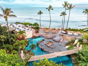 an aerial view of a resort with a pool and the ocean at Hyatt Regency Maui Resort & Spa in Lahaina