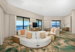 a living room with a white couch and chairs at Hyatt Regency Maui Resort & Spa in Lahaina