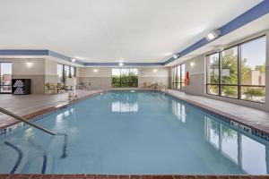 a large swimming pool with blue water in a building at Hampton Inn & Suites Crawfordsville in Crawfordsville