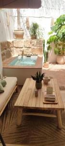 a room with a table and a swimming pool at Ca La Portella in Jávea +23 photos
