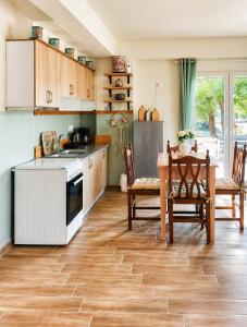 a kitchen with wooden floors and a table with a stove at EuZoea Country Home 2 Nature Escape with Pool in Kapandrítion