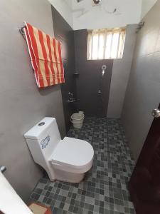 a small bathroom with a toilet and a shower at Traditional Villa Munnar in Anachal