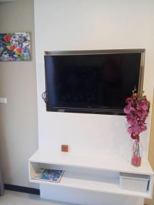 a flat screen tv on a white wall at Vacation by the ocean in Phuket