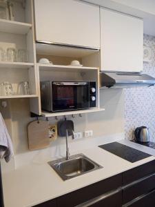 a kitchen with a sink and a microwave at Vacation by the ocean in Phuket