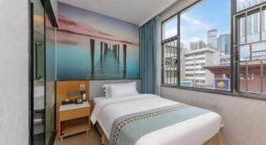 a bedroom with a bed and a large window at Zhenxing Hotel in Shenzhen +62 photos