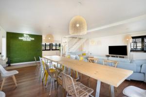 a dining room with a long table and chairs at Camino Blanco in Ibeas de Juarros