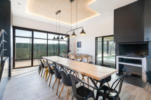 a dining room with a large wooden table and chairs at Camino Blanco in Ibeas de Juarros