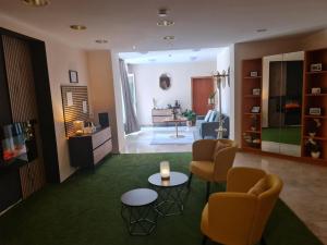 a living room with chairs and a table and a couch at Hotel Rheinland in Bad Orb