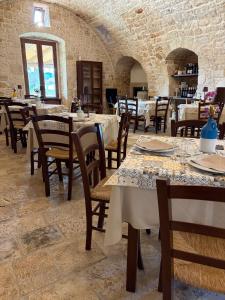 a restaurant with tables and chairs in a room at Masseria Fanizzi in Conversano