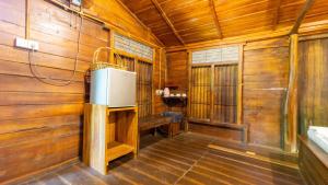 a room with a refrigerator in a wooden cabin at Golden Rainbow Guest House in Dambulla