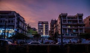 a group of buildings in a city at dusk at Lumis Beach Hotel in Visakhapatnam