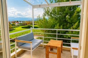 a porch with a chair and a table at EuZoea Country Home 3 Nature Escape with Pool in Kapandrítion