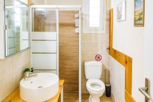 a bathroom with a toilet and a sink at EuZoea Country Home 3 Nature Escape with Pool in Kapandrítion +23 photos