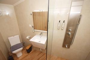 a bathroom with a toilet and a sink and a shower at Nina's House by CorfuEscapes in Doukádes +32 photos