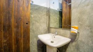 a bathroom with a sink and a mirror at Golden Rainbow Guest House in Dambulla +46 photos