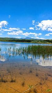 a large body of water with grass in it at EuZoea Country Home 3 Nature Escape with Pool in Kapandrítion