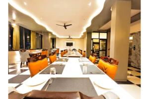 a dining room with a long table and an airplane on the ceiling at FabHotel The Crystal in Udaipur