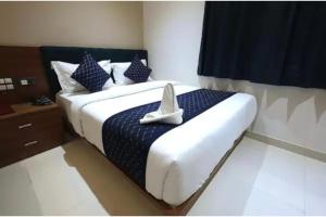 a bedroom with a bed with a cross on it at FabHotel The Crystal in Udaipur