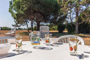 a table with glasses of water on top of it at Duplex N°1 - Résidence Balnéaire in Le Port-des-Barques