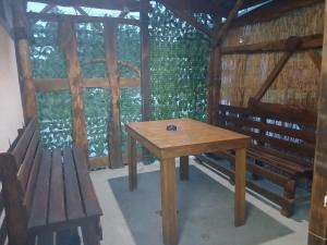 a wooden table and a bench in a room at Apartman Retro 2 in Žepče