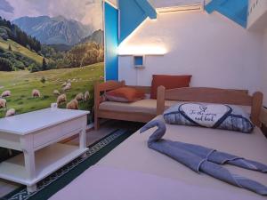 two beds in a room with a painting on the wall at Apartman Retro 2 in Žepče