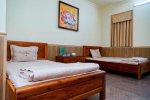 a bedroom with two beds and a window at Bavieco Resort in Yên Bài +95 photos