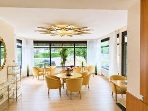 a dining room with a table and chairs at Hotel Rheinland in Bad Orb