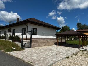 a house with a gazebo in front of it at Prázdninový dům MAJKA in Mosty u Jablunkova