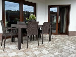 a dining room table and chairs on a patio at Prázdninový dům MAJKA in Mosty u Jablunkova
