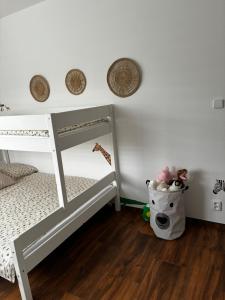 a white bunk bed in a room with a wooden floor at Prázdninový dům MAJKA in Mosty u Jablunkova