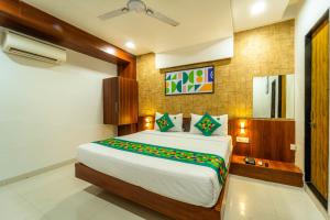 a bedroom with a large bed in a room at Treebo Ten Eleven Grand, Scheme 78 in Indore +24 photos